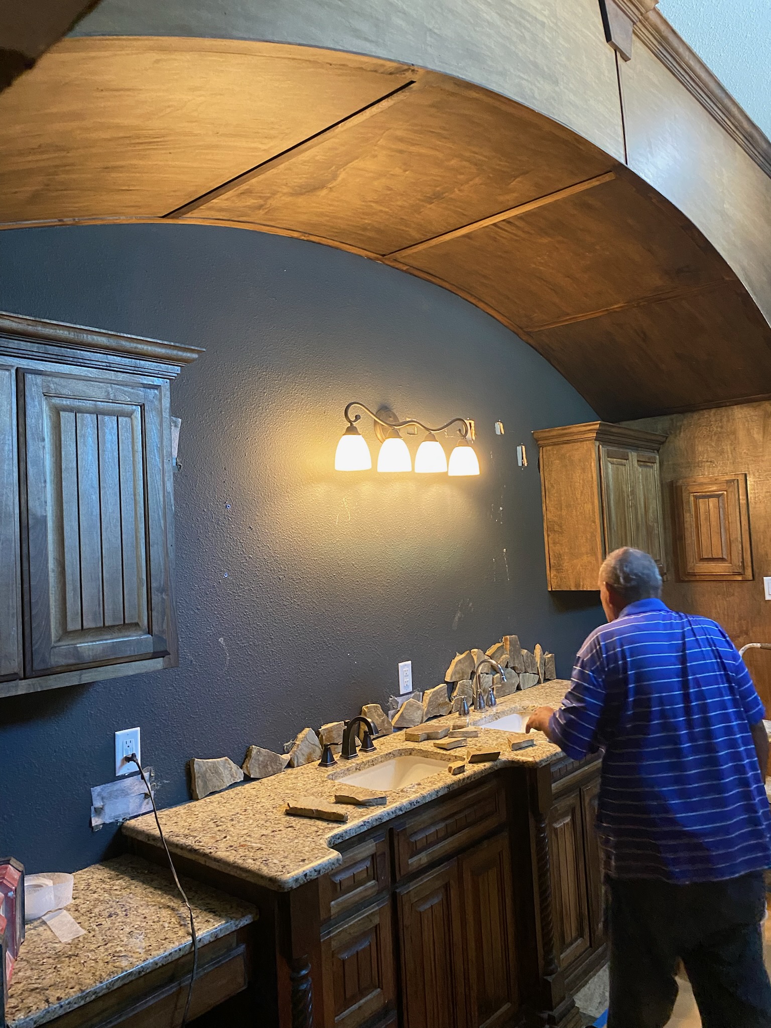 Bathroom vanity with natural stone backsplash