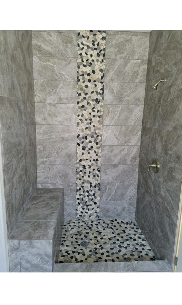 Finished shower with river pebble mosaic accent stripe and built-in bench